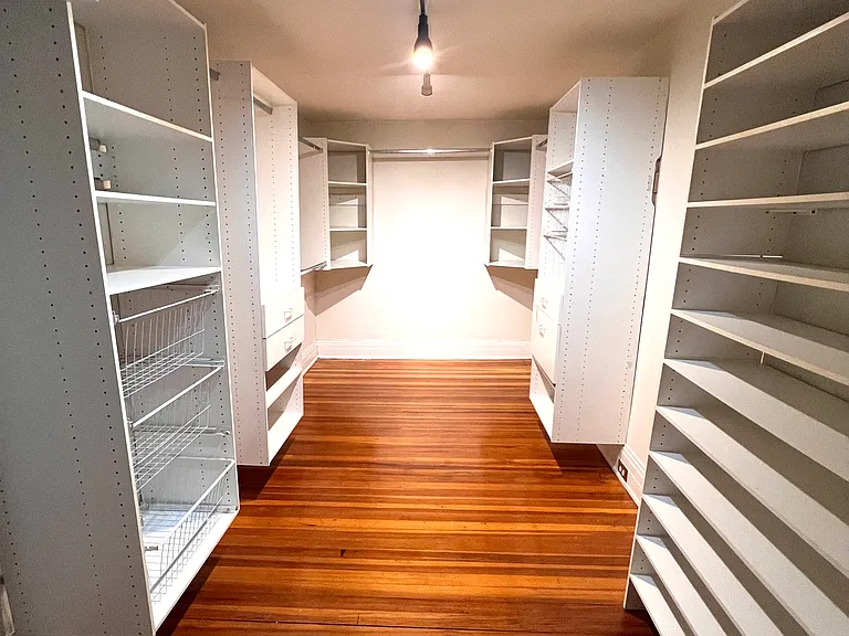 Primary bedroom walk-in closet