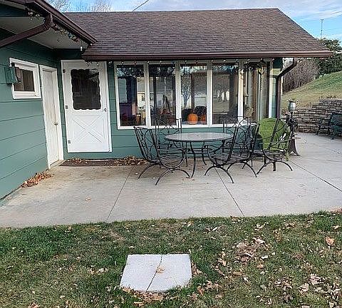 Back patio area with sunroom