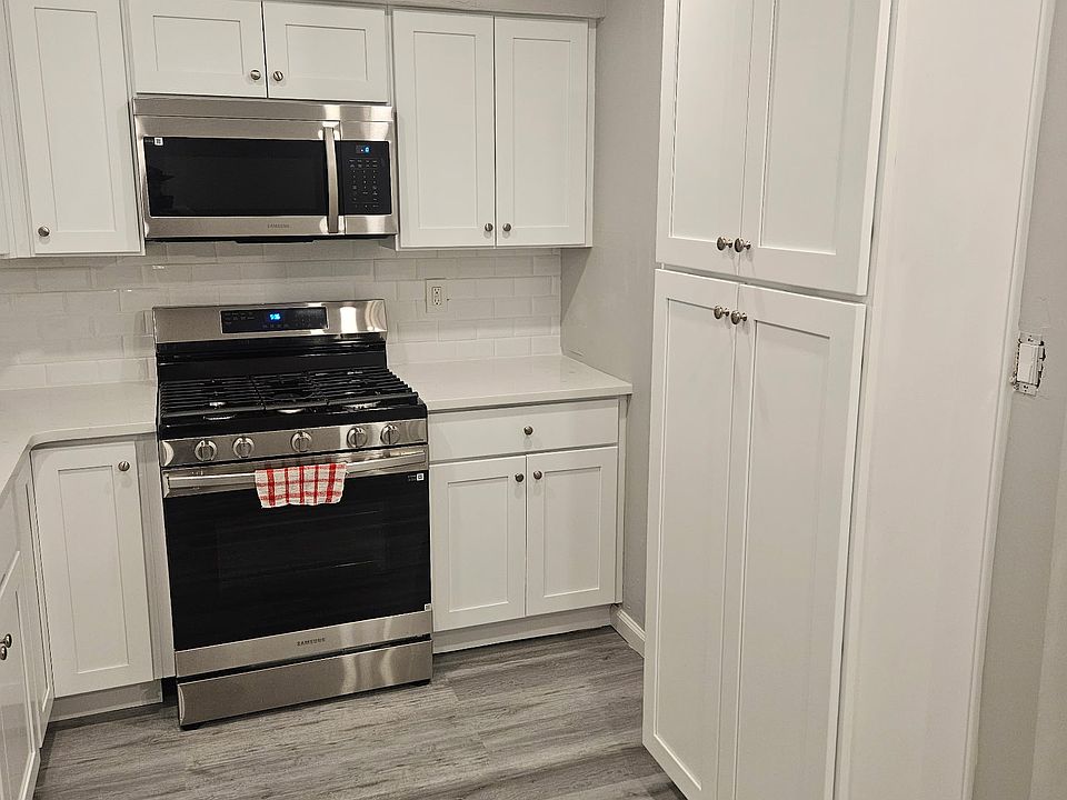 Kitchen w/ Stainless Steel Appliances, Gas Stove, Refrigerator/Freezer with Ice and Water Dispenser, and a pantry.