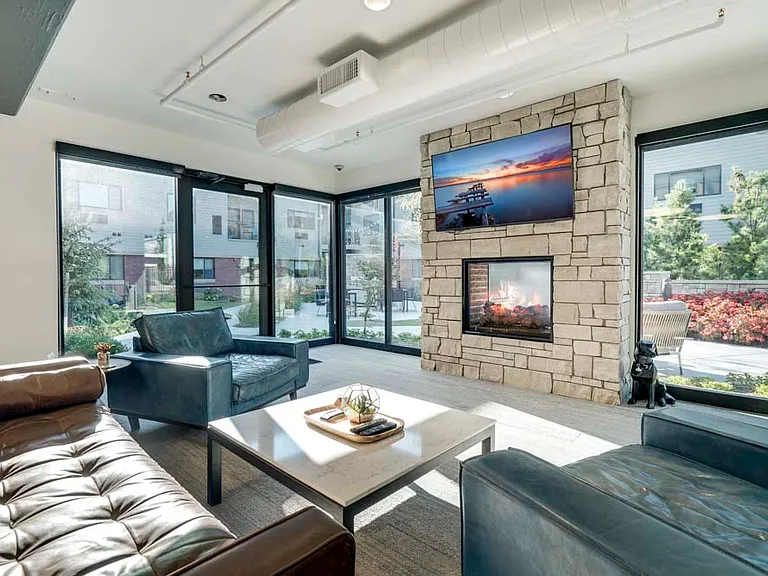 Our TV lounge offers ultimate views of the pocket park, along with a two-way fireplace.