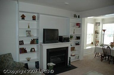 Custom built-in bookshelf over gas fireplace