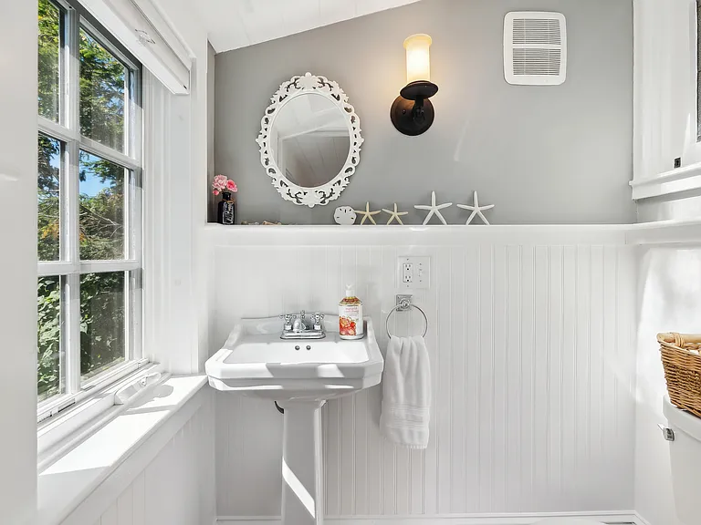 Adorable powder room at the end of the side entrance.