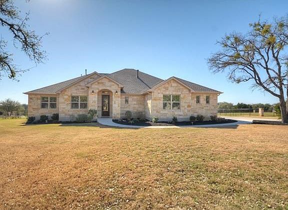 A full stone exterior and Three-Car Side-entry Garage invite you to see more of this Shady Oaks Esta