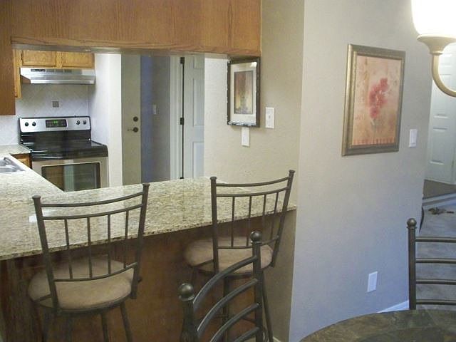 Breakfast bar with new Venetian Gold granite counter tops.