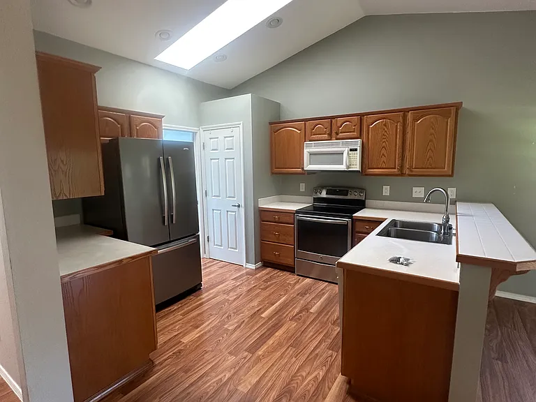 Kitchen with skylight and counter seating.
