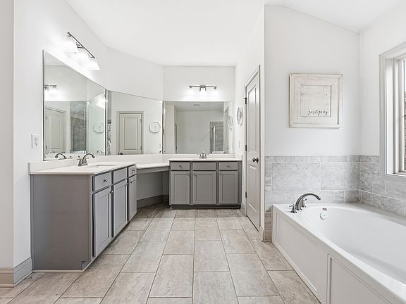 Oversized double vanity with ample counter space and storage, creating a functional and comfortable primary bath.