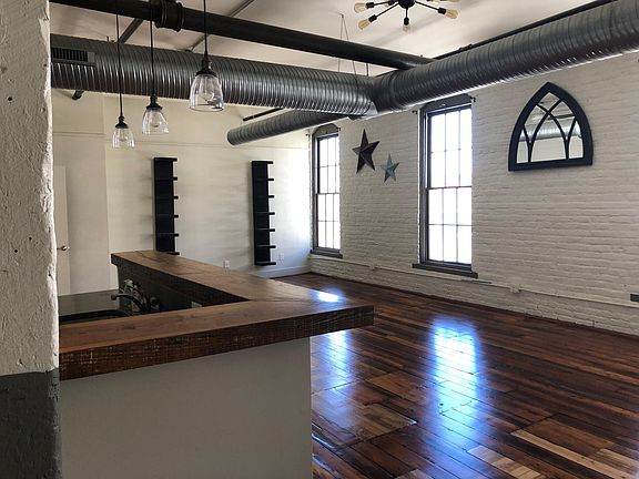 Open concept kitchen, living, dining space with huge windows.