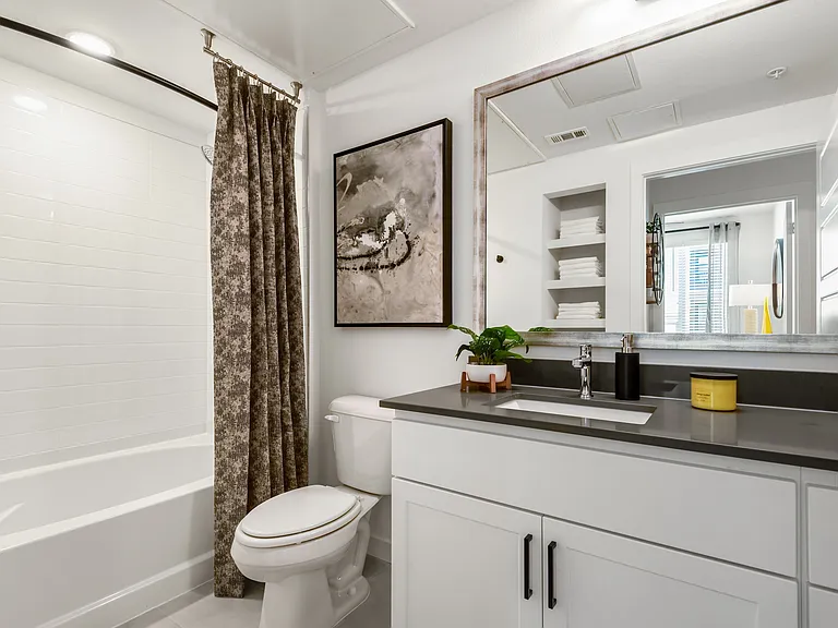 Stylish Bathroom with Modern Fixtures and Built-In Shelving