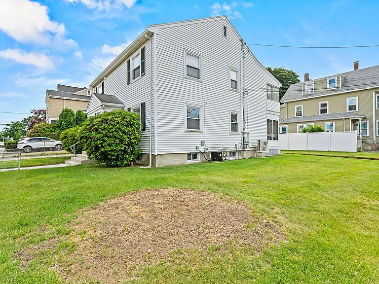 Full wrap around yard shared between 2 units. Landscaping included.