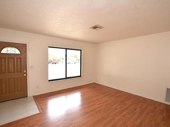 Light and bright with wood laminate flooring.