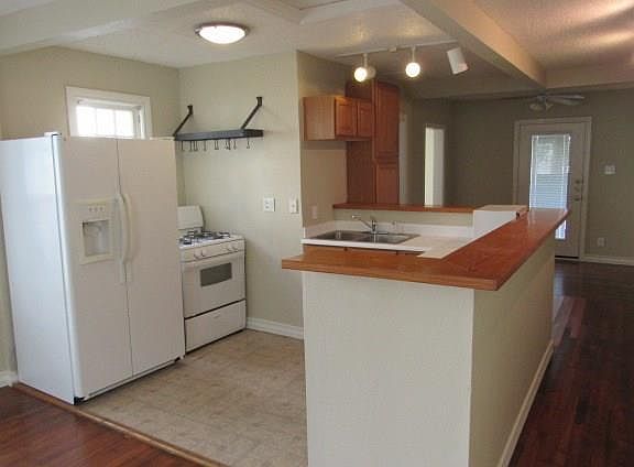 Kitchen opens to entry and dining/living areas.