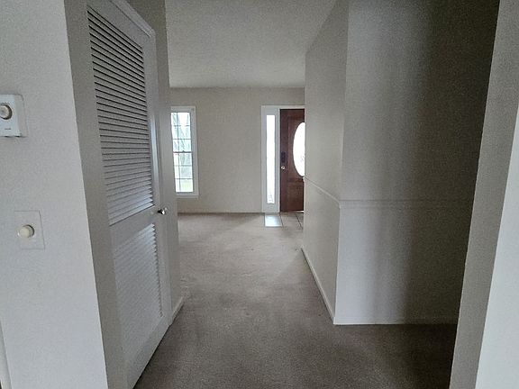 From dining room to living room. Furnace closet on left, hall to bedrooms and bathroom on right.