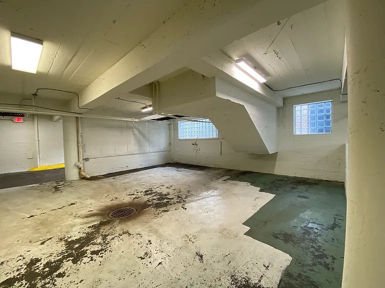 Existing floor drains add practicality and functionality, making the space particularly well-suited for automotive, mechanical, and workshop applications.