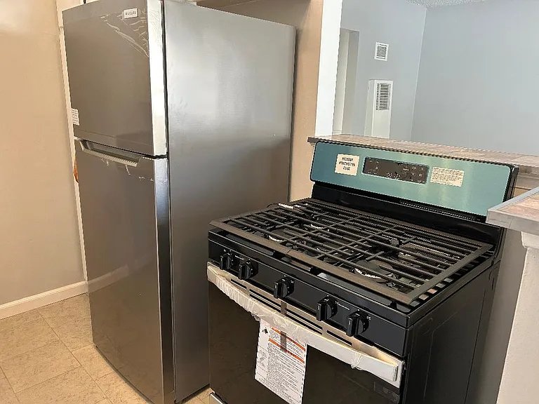 Brand new Whirlpool 5 burners gas stove and brand new big Frigidaire refrigerator