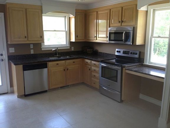 Gourmet kitchen with granite tops stainless appliances and a