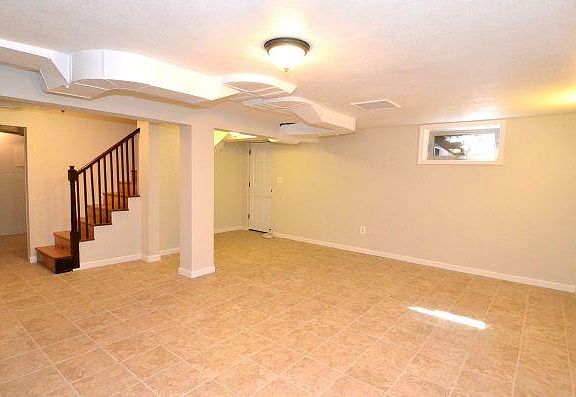 Living Rm - private entrance. Shelves under stairs.