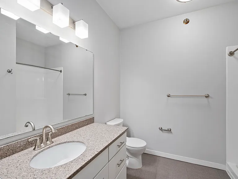 Modern bathroom with elegant vanity, sleek fixtures, and spacious layout. Modern bathroom with elegant vanity, sleek fixtures, and spacious layout.