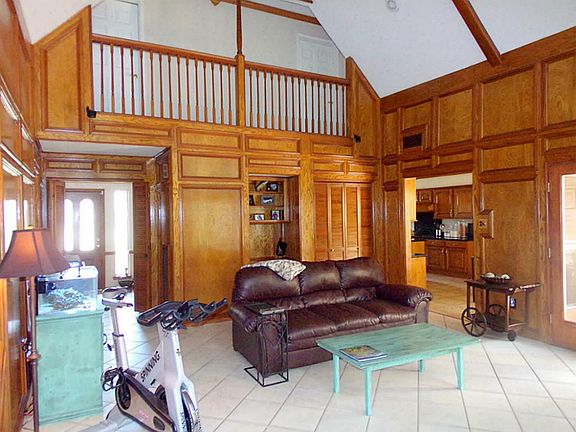 WOW! Two story living area with refinished paneling, tile floors, custom built in cabinets and more.