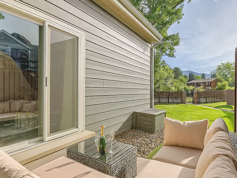 Patio with plush seating, perfect for sipping wine and soaking in mountain views.