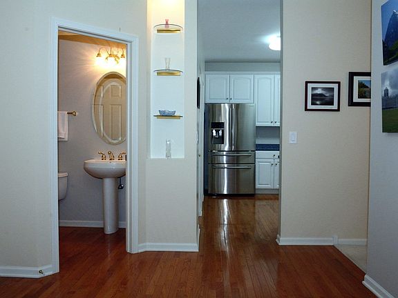 Looking from the entry way to the kitchen and powder rm. Notice the real hard wood fls
