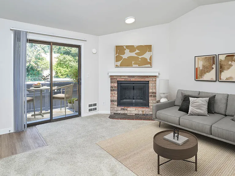 Carpeted Living Room with Fireplace and Balcony