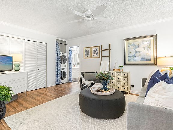 Comfortable living space featuring storage and easily accessible washer and dryer.