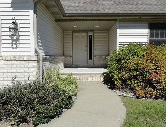 The curved front entrance sidewalk leads one to a fully covered sizable front porch.