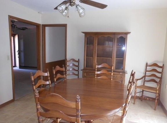 Dining area with ceiling fan and French doors to backyard
