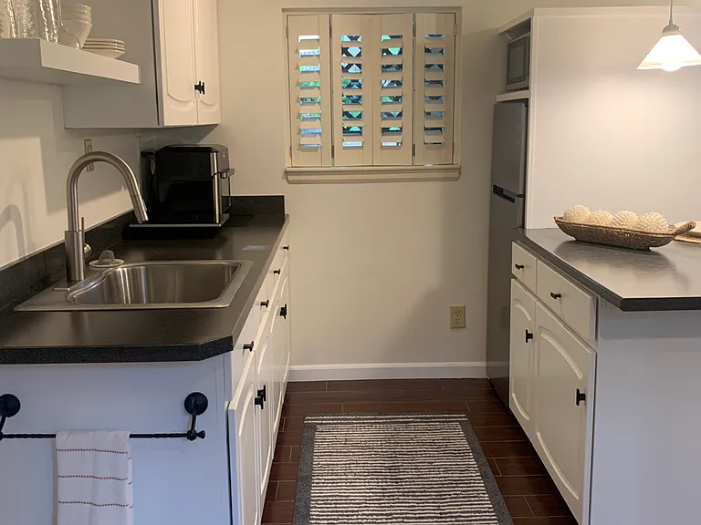 kitchenette with apartment size refrigerator/freezer,microwave, air fryer,and invention plate.
