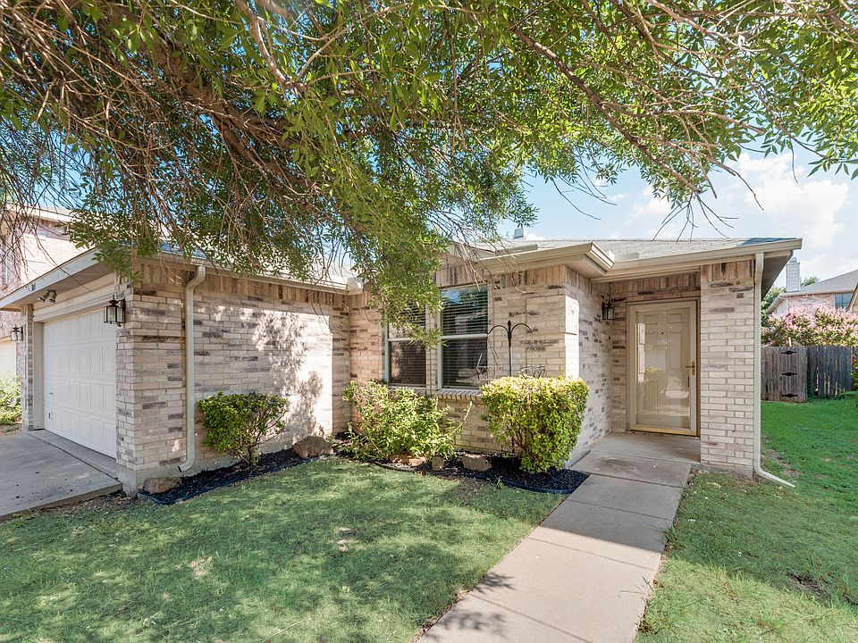 Ranch-style home with a garage and a front lawn