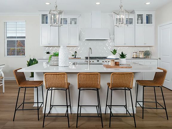 Kitchen with glass upper cabinets and pendant lighting