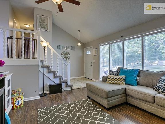 Light and bright great room with wood flooring.
