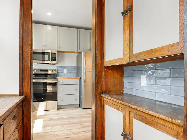 THhis is the upstairs butler's pantry leading into the kitchen from the dining area.