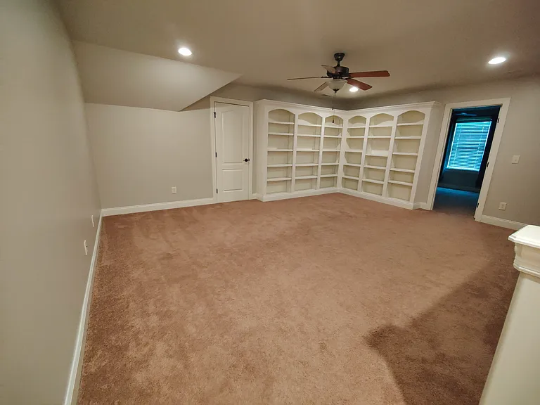 Upper level recreation room or library. This room has no windows and has doors to attic and upstairs bedroom.