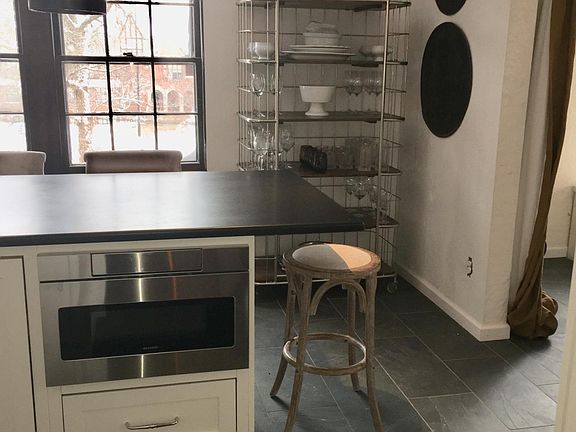 Professionally designed kitchen offers seating for 3 around 