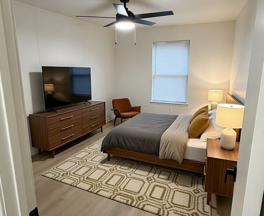 Large bedroom with extra large closet including built in shelves and hanging racks. Window looking onto private, fenced-in backyard.