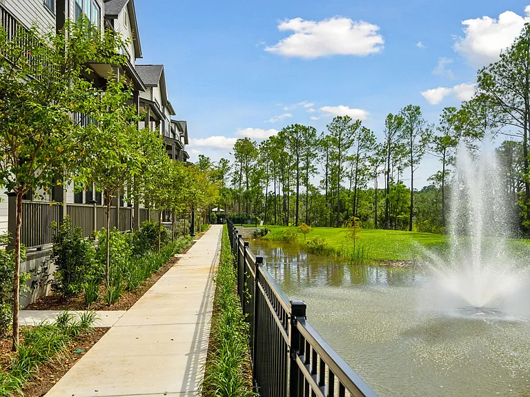 Overlooking pond with pathway to the resort-style pool