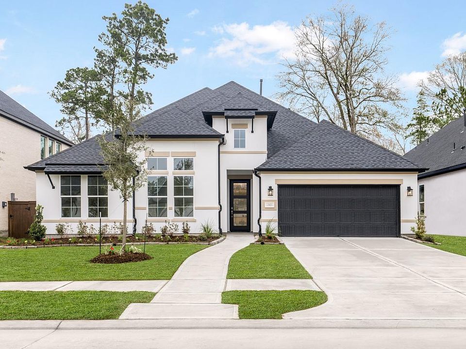 Gorgeous stucco home with dark finishes and full landscaping