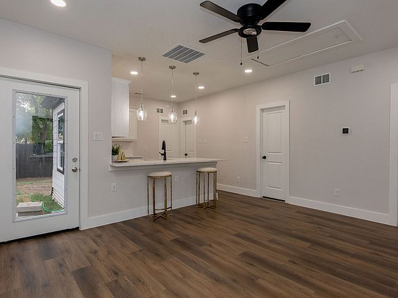 Great Room with breakfast bar, Wifi thermostat, ceiling fan, pendant lighting, exterior back door