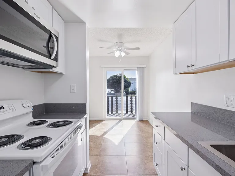Airy kitchen view across dining area