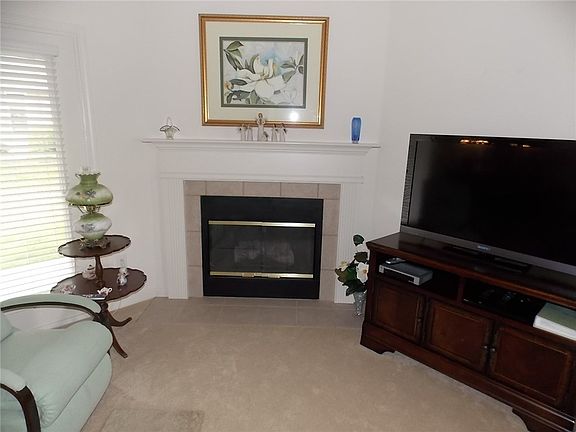 Attractive gas log fireplace in great room.