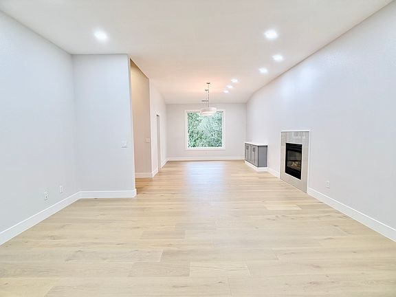 To the right of the entry, a spacious dining and living area features a built-in buffet and a gas fireplace.