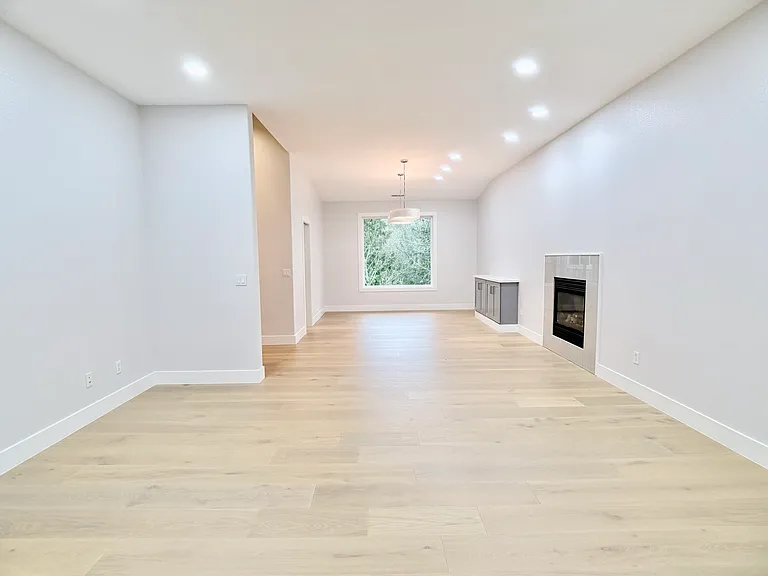 To the right of the entry, a spacious dining and living area features a built-in buffet and a gas fireplace.