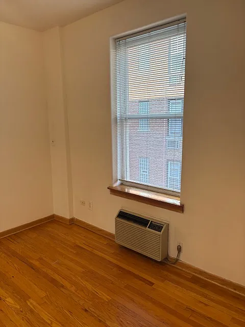 Bedroom facing landscaped courtyard.
Heating/air-conditioner below window.