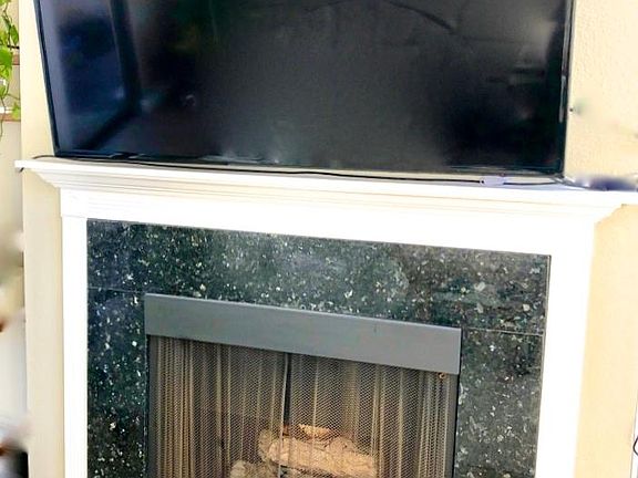 Picture of the custom fireplace hearth and mantel added. Television does not come with condo:-)