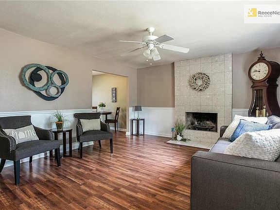 2nd view - Living Room with Wainscoating and ceiling fan.