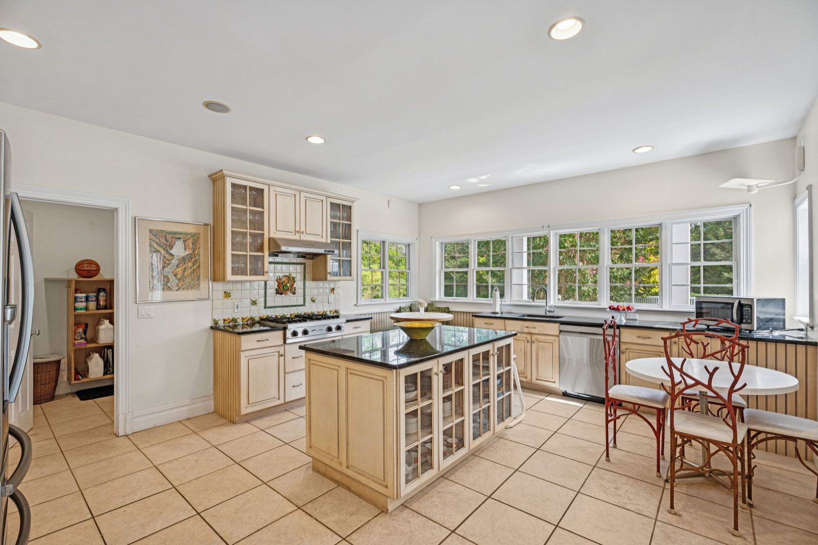 A beautifully appointed kitchen adorned with granite countertops, and a central island.