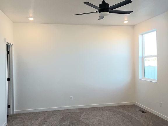 Primary bedroom with ceiling fan
