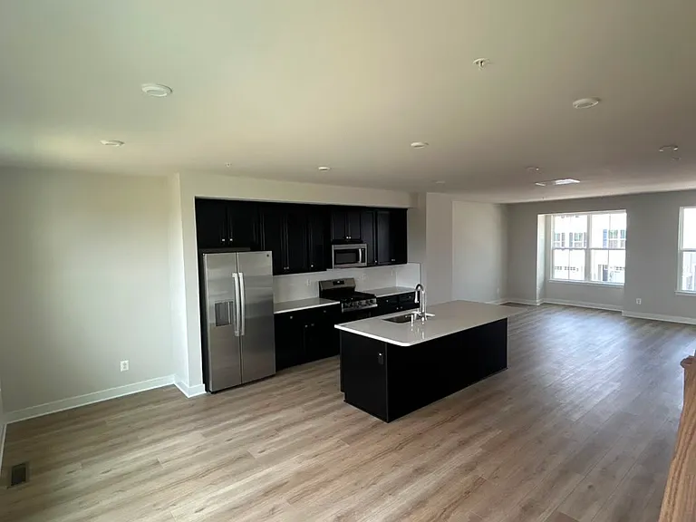 2nd floor kitchen with center island - stainless steel appliances like Refrigerator, Gas range, microwave, dishwasher, garbage disposal