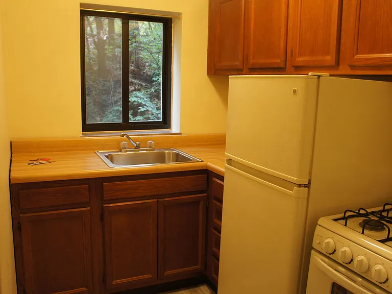 KITCHEN EQUIPPED WITH GAS RANGE AND REFRIGERATOR